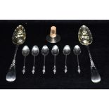 A PAIR OF GEORGIAN SILVER BERRY SPOONS With embossed fruit decoration to silver gilt bowls (possibly