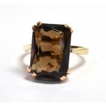 A SMOKY QUARTZ SINGLE STONE 9CT GOLD DRESS RING the rectangular cut smoky quartz 14 x 10mm, claw set