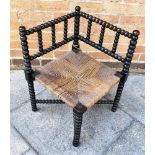 AN EBONISED BOBBIN TURNED CORNER CHAIR, 61cm high