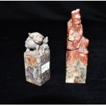 TWO CHINESE CARVED STONE SEALS one carved as dog of Fo 8.5cm high; the other carved as a figure with