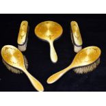 A SILVER AND GOLDEN YELLOW ENAMELLED FIVE PIECE BRUSH SET