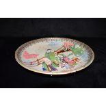 A JAPANESE BANKO WARE CHARGER decorated in the Chinese taste with Shou Lao and other figures in a