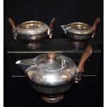 AN ART DECO SILVER PLATED THREE PIECE TEA SET with hardwood handles, stamped to base with maker 'Wm.