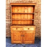 VICTORIAN PINE DRESSER, the upper section having a panelled with a cornice above a two shelf plate