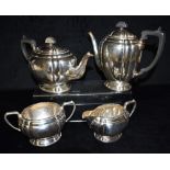 A SILVER FOUR PIECE TEA SET of rounded oval shape with four lobed decoration on pedestal bases