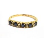 A SAPPHIRE AND DIAMOND HALF ETERNITY RING Five small sapphires alternating with pairs of small