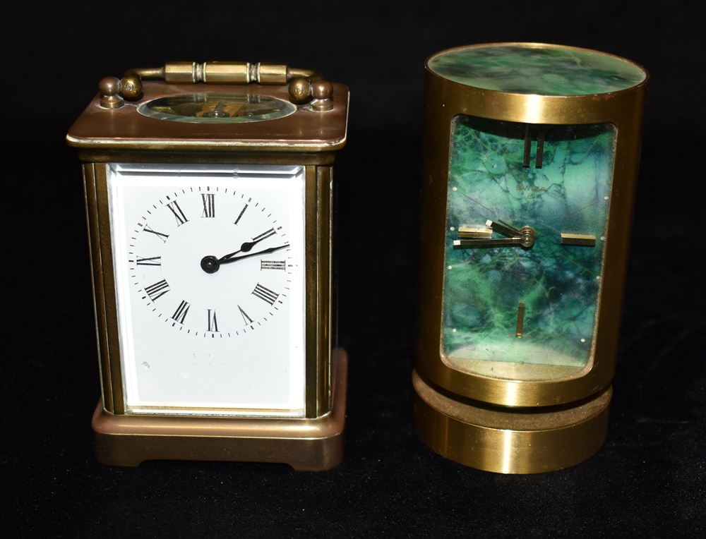 A BRASS CASED CARRIAGE CLOCK 11.5cm high with handle down, and a mid-century Swiza cylindrical