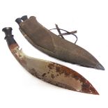 MILITARIA - A KUKRI the 36cm typically curved blade with a hardwood grip, in its leather sheath,