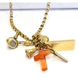 A LONG CHAIN CHARM NECKLACE Of mixed metal to include a marked 9ct gold ingot and a miniature yellow