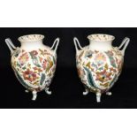 A PAIR OF ZSOLNAY PECS STYLE TWIN HANDLED VASES with polychrome enamelled floral decoration on a