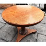 AN OAK TILT TOP CIRCULAR TABLE, the top 93cm diameter, raised on a circular base support with a