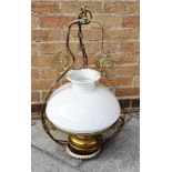 AN EDWARDIAN HANGING OIL LAMP with opaque glass shade, the metal frame wtih Art Nouveau style