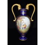 A CONTINENTAL TWIN-HANDLED VASE with painted reserve of a lady with cherub in Classical garden