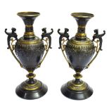 A PAIR OF 19TH CENTURY CAST METAL URNS the twin handles modelled with mythological creatures, on
