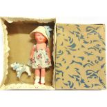 A SMALL PAINTED PLASTER DOLL & HER DOG circa 1930s, 14.5cm high, in original box.