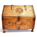 A GEOMETRIC CARVED BOX with compass decoration, possibly of Scandinavian origin, and raised on