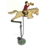A PAINTED METAL BALANCE TOY in the form of a huntsman on a leaping horse, overall 50cm high.