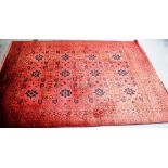 A LARGE RED GROUND RUG 207cm x 294cm