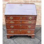A GEORGE III PROVINICIAL OAK BUREAU with fitted interior above four long graduated drawers, on