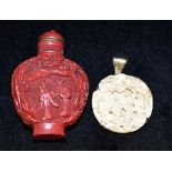 A 20TH CENTURY CHINESE CARVED CINNABAR LACQUER SNUFF BOTTLE relief decorated to each side with