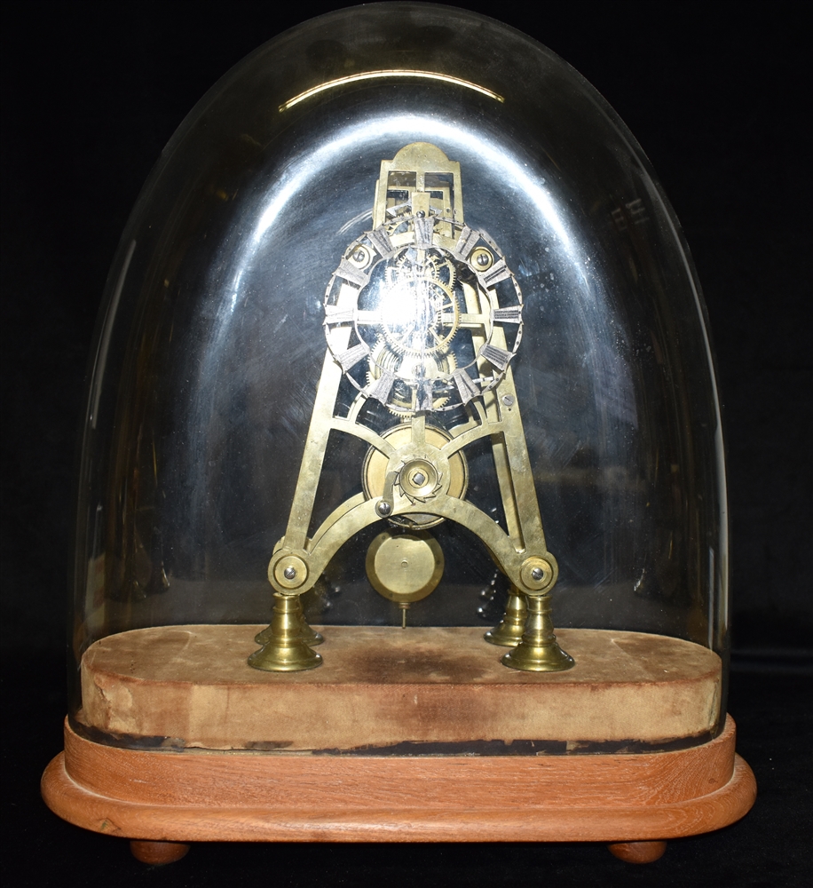 A SINGLE FUSEE BRASS SKELETON CLOCK unsigned, on velvet and wooden base with glass dome, 46cm high