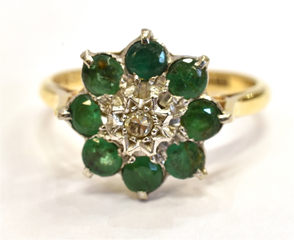 AN 18CT GOLD DIAMOND SET GREEN STONE FLOWER RING hallmarked Birmingham 1968, the central diamond set