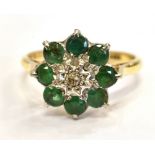 AN 18CT GOLD DIAMOND SET GREEN STONE FLOWER RING hallmarked Birmingham 1968, the central diamond set