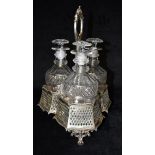 A VICTORIAN SILVER THREE PIECE DECANTER SET of open work detail and floral scroll handle and with