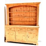 20TH CENTURY PINE DRESSER, the upper section of three shelf configuration and having a panelled