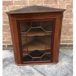 MAHOGANY WALL HANGING CORNER CUPBOARD with a pair of glazed doors opening to reveal to glass