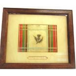 A WOVEN TARTAN-STYLE SILK PANEL mounted with a hand-written label 'Spitalfields Silk / From the