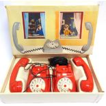 A VI-PA (ITALY) PAIR OF TELEPHONES INTERCOMMUNICANTS of red plastic with clear plastic ring dials,