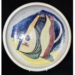 AN ART POTTERY PLATE decorated with a mandolin and ewer in the manner of Picasso and dated '1948',