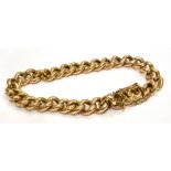 A YELLOW METAL CURB LINK BRACELET weighing approx. 14.6 grams, push clasp and safety chain
