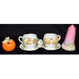 A CLARICE CLIFF NEWPORT POTTERY PAIR OF MUGS ON STAND decorated in the 'Celtic Leaf and Berry'