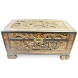 A TABLE TOP CAMPHORWOOD TRUNK the top and sides having carved decoration depicting figures in