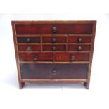 A WORKBENCH TOOL CHEST comprising ten drawers of varying sizes, many with internal divisions, the