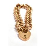 A ROSE GOLD CURB LINK BRACELET Fitted with a gilt metal heart padlock clasp and gilt metal