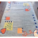 A BLUE GROUND RUG with abstract design, 122cm x 180cm