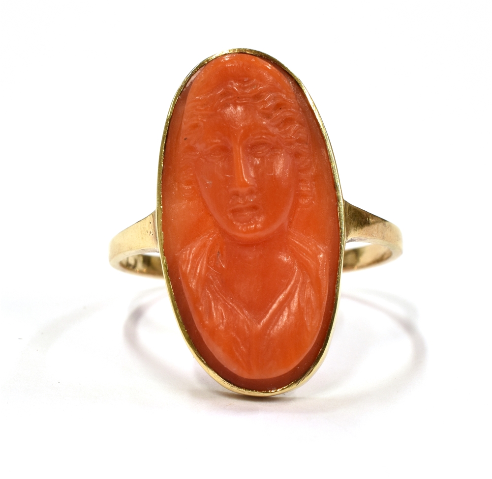 A CAMEO COCKTAIL RING With the coral coloured hardstone cameo measuring approx. 2cm by 1cm on a