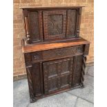 AN OAK COURT STYLE CUPBOARD of small proportion, with profusely carved decoration to the front the