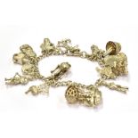 A SILVER AND WHITE METAL CHARM BRACELET weighing 57.6grams