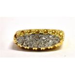 AN 18CT GOLD DIAMOND BOAT RING With the platinum head set with 12 small single cut diamonds, the