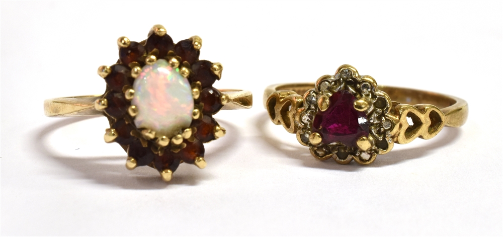 A 9CT GOLD RUBY SET RING With the central ruby shaped as a heart and the ring shoulders of open work