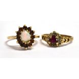 A 9CT GOLD RUBY SET RING With the central ruby shaped as a heart and the ring shoulders of open work