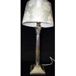 A TABLE LAMP WITH SILVER PLATED CORINTHIAN COLUMN BASE with cream coloured silk shade 67cm high