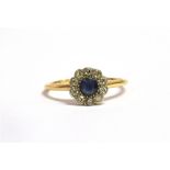 AN ART DECO DIAMOND AND SAPPHIRE DAISY HEAD GOLD RING With the central faceted round cut sapphire of