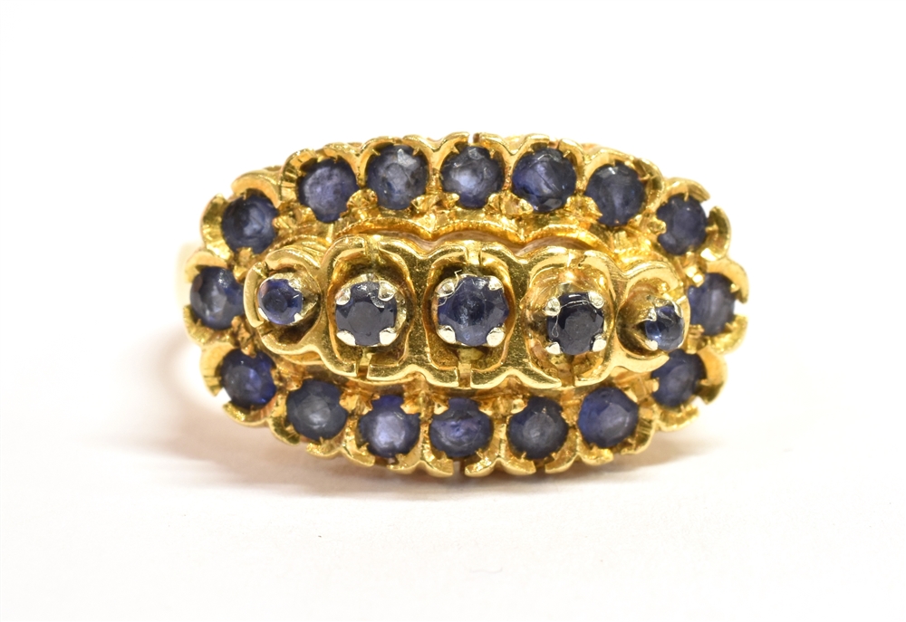 AN 18CT GOLD SAPPHIRE CLUSTER RING The boat shaped cluster head set with 21 small sapphires with the
