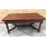 A CARVED EXTENDING DINING TABLE, of rectangular form, with a draw leaf to each side, raised on