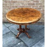 A WALNUT CIRCULAR TABLE the top measuring 90cm diameter, raised on four circular columns with